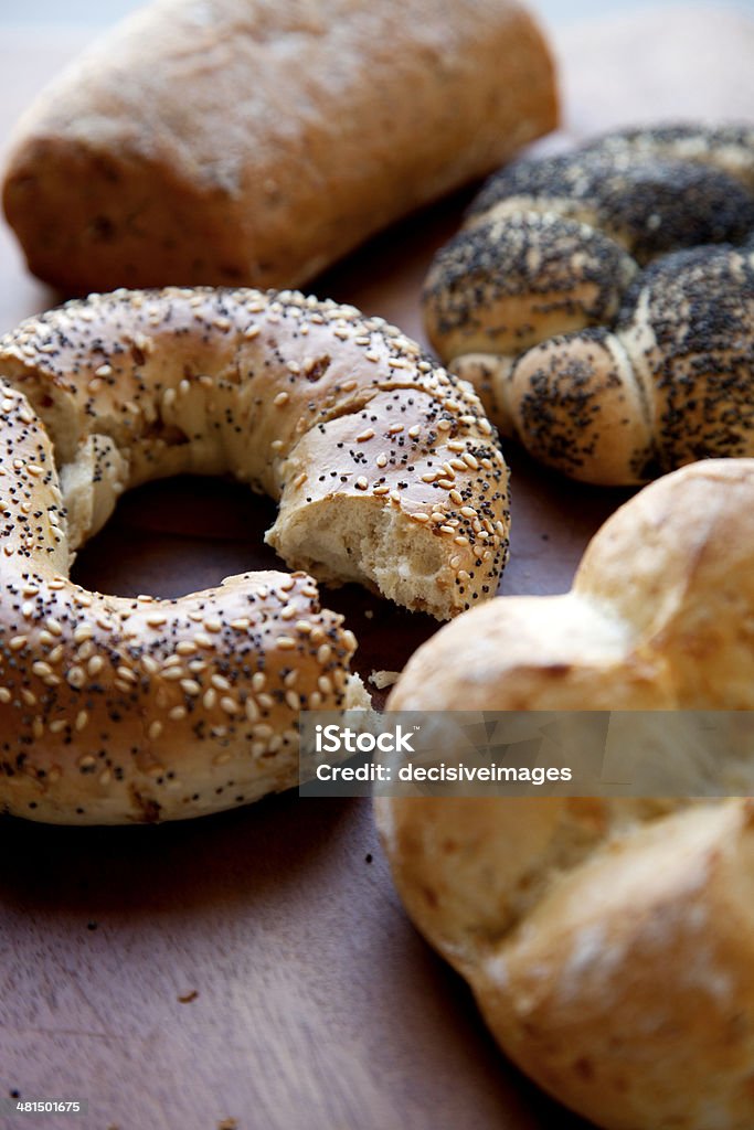 Freshly baked bread rolls Delicious freshly baked bread rolls on a wooden board. Bagel Stock Photo