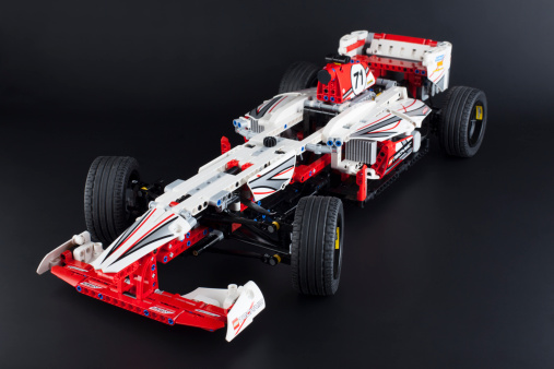 Tambov, Russian Federation - January 12, 2014: LEGO Technic Grand Prix Racer model on black background. Item 42000. It model motorized with 8293 LEGO Power Functions Motor Set. Studio shot. There are some dust on the tires.