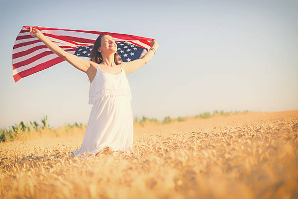 istock Woman holding an American flag 481505254