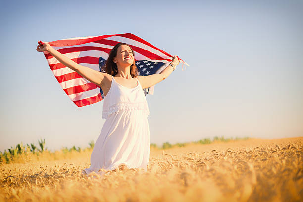 istock Woman holding an American flag 481505266