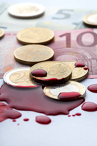 European Currency Euro coins and banknotes in a puddle of blood bloody money stock pictures, royalty-free photos & images