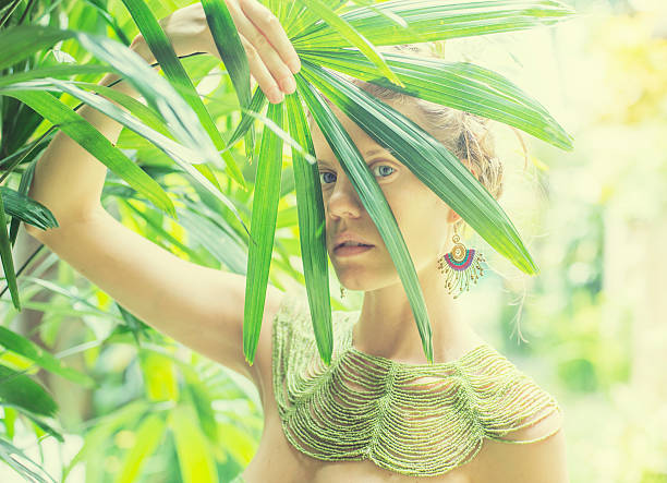 istock beautiful women in tropical leaves 481510003