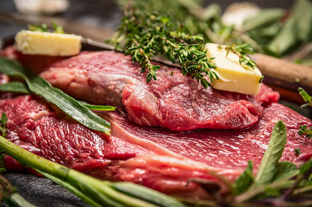 Raw beef steak with herbs and butter for cooking