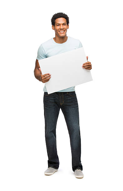 Casual latin young man holding sign