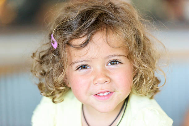 Caucasian beautiful little child looking at the camera smiling