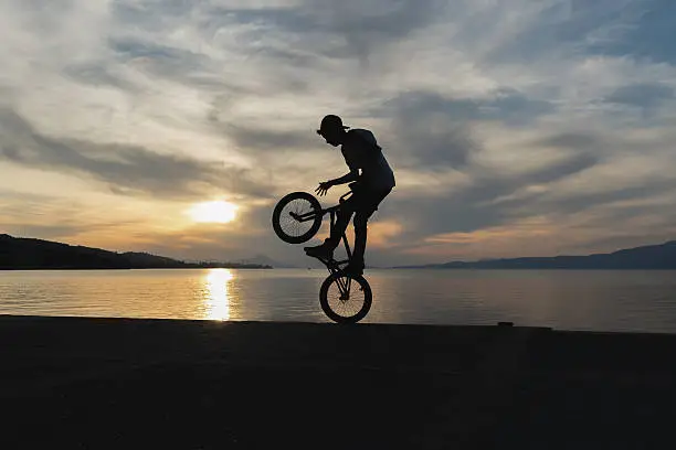 Biker jumping with the sunset as background.