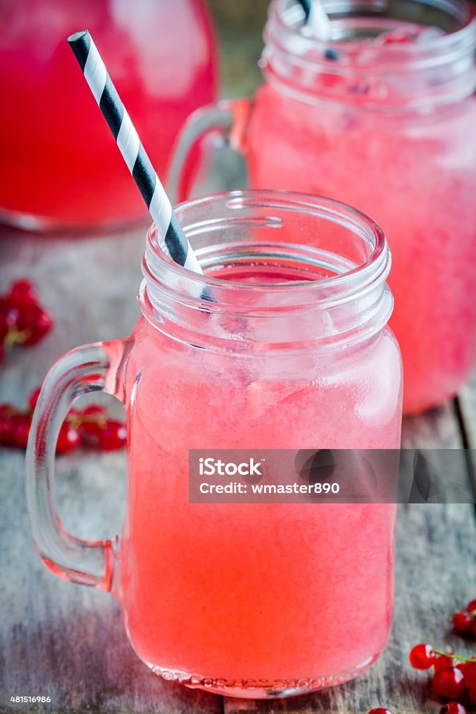 homemade red currant lemonade in a mason jar homemade red currant lemonade in a mason jar on wooden table 2015 Stock Photo