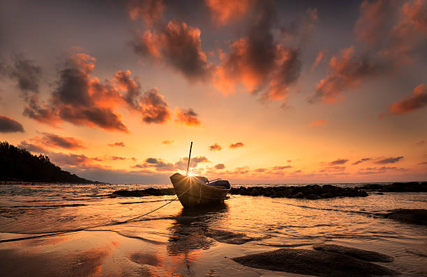 Boats at the beach during sunset