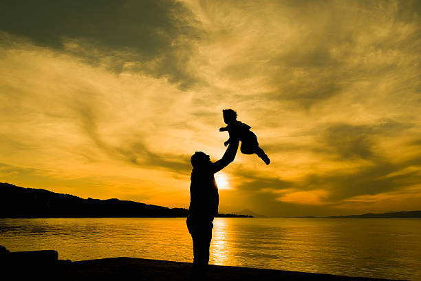 istock Family loving moment with father and son against dramatic sky. 481520794