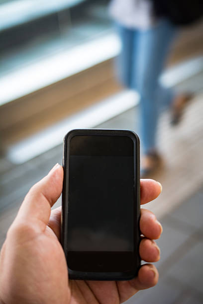 istock Checking smartphone with suitcase  walking woman in backdrop 481520894