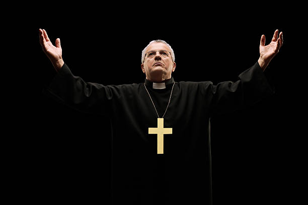 istock Mature priest praying to god 481521141