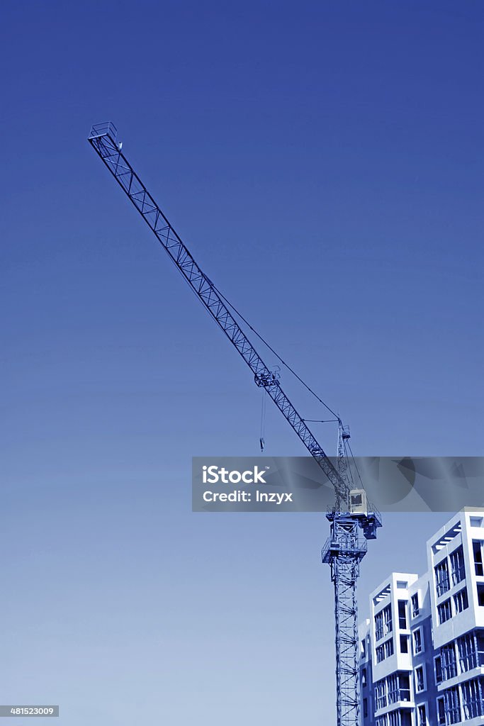 high-rise building and crane high-rise building and crane in the blue sky, colorful, very tall and spectacular. Apartment Stock Photo