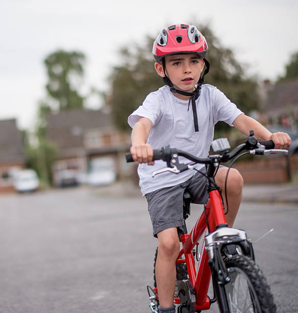 istock Boy riding a bike outdoors with a helmet 481523644