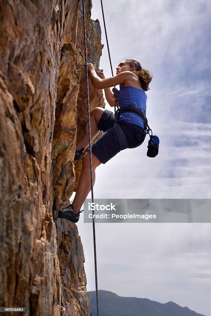 Higher and higher... Shot of a young woman concentrating very hard as she climbs up a cliffhttp://195.154.178.81/DATA/i_collage/pi/shoots/783150.jpg Challenge Stock Photo