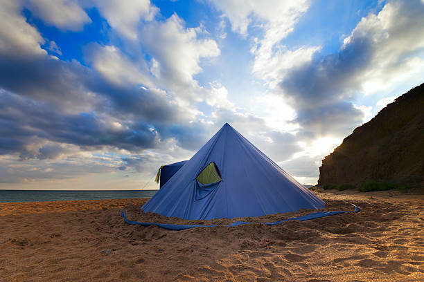 istock Conical tent on summer beach and blue sky with clouds 481529467