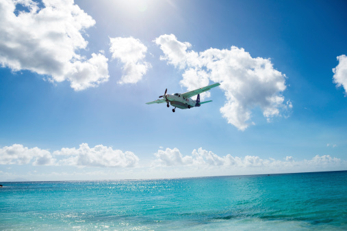 Maho Bay, St Maarten, Netherlands Antilles - November 15, 2013: A FedEx Feeder plane comes in for landing at Princess Juliana International Airport in St. Maarten. The plane is a Cessna 208B Grand Caravan.