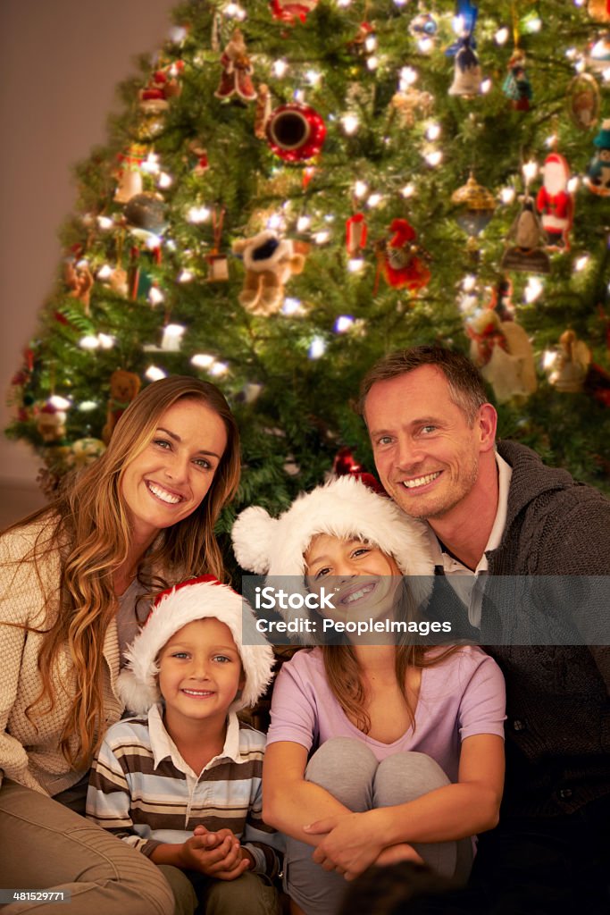 Making memories at Christmas time Portrait of a happy young family on Christmas day Adult Stock Photo