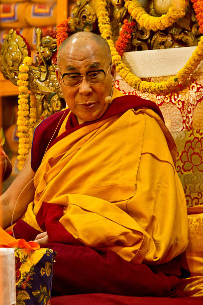 The Dalai Lama teaching in Dharamsala, India Dharamsala, India - September 24, 2014: The Dalai Lama gives his bi-annual teachings at the Dalai Lama Temple, Mcleod Ganj, Dharamsala, India dalai lama stock pictures, royalty-free photos & images