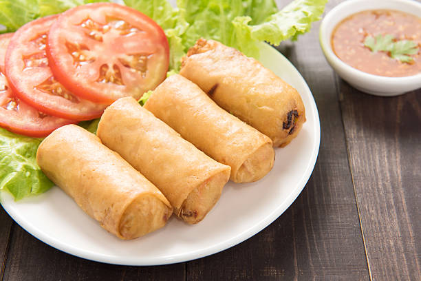 istock Fried Chinese traditional spring rolls on wooden background. 481535550