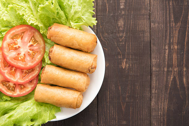 istock Fried Chinese traditional spring rolls on wooden background. 481536054