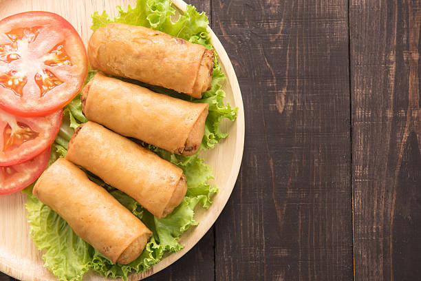 istock Fried Chinese traditional spring rolls on wooden background. 481536056