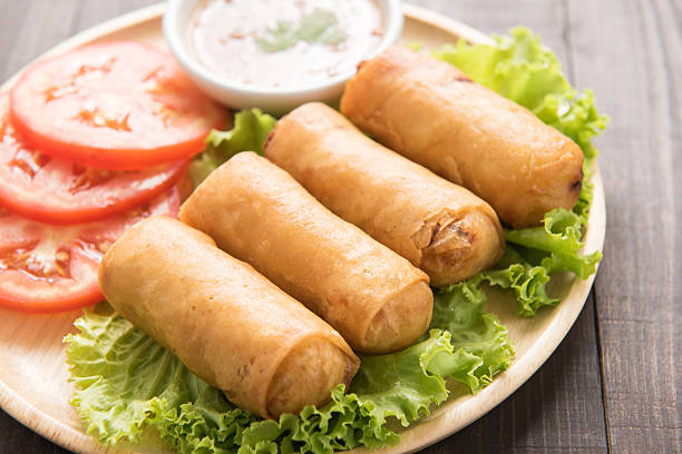 istock Fried Chinese traditional spring rolls on wooden background. 481536058