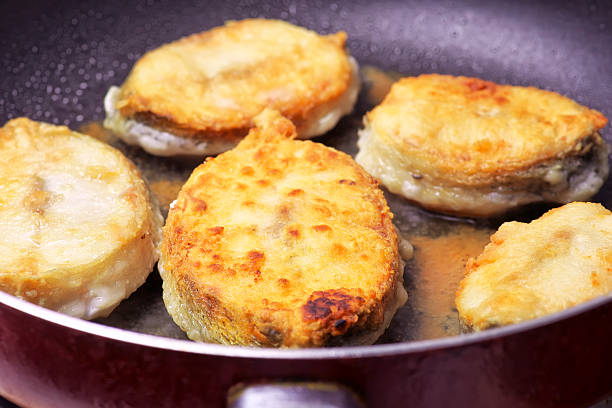 istock Pieces of fried fish in a frying pan 481536160