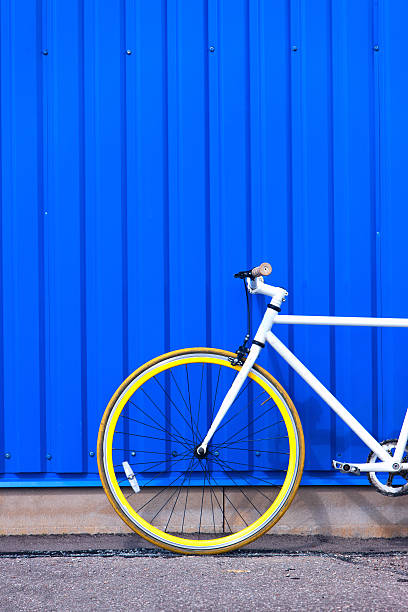 istock White bike at the blue wall with stripes 481539778