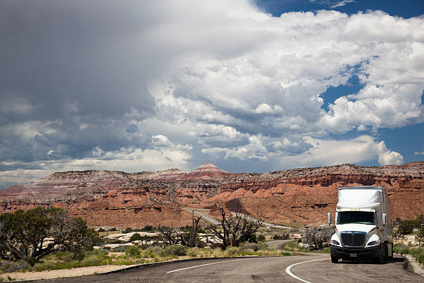 istock white truck under threatening sky on Utah desert highway 481541604