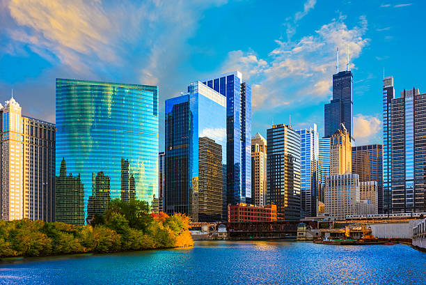 Skyscrapers of Chicago skyline at sunset,Chicago River,Ill Chicago River reflects the sunset colors in the foreground leading back to the main architectural skyline of Chicago, Illinois chicago illinois stock pictures, royalty-free photos & images