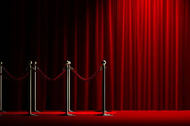 Velvet red rope barrier with a shining curtain on the right
