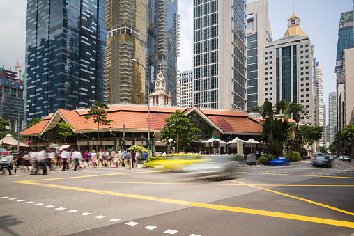 Office workers taking the pedestrian crossing going for lunch break at the Telok Ayer Market aka Lau Pa Sat, Singapore.
