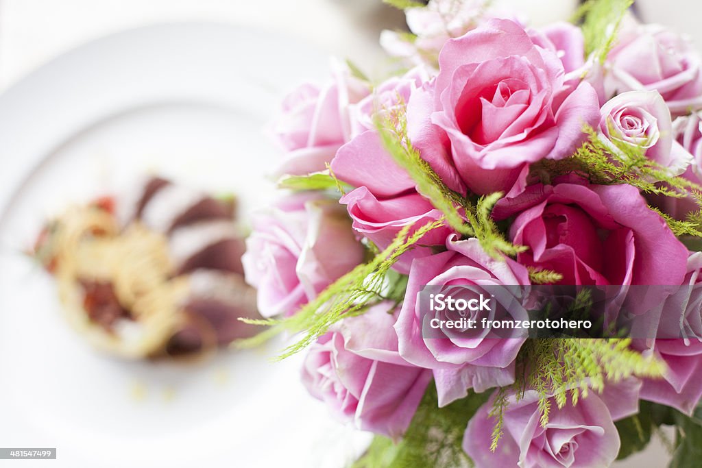 Pink rose flower on front of Beef medallions Asparagus Stock Photo