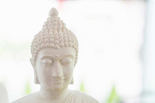 white buddha figure in blur background