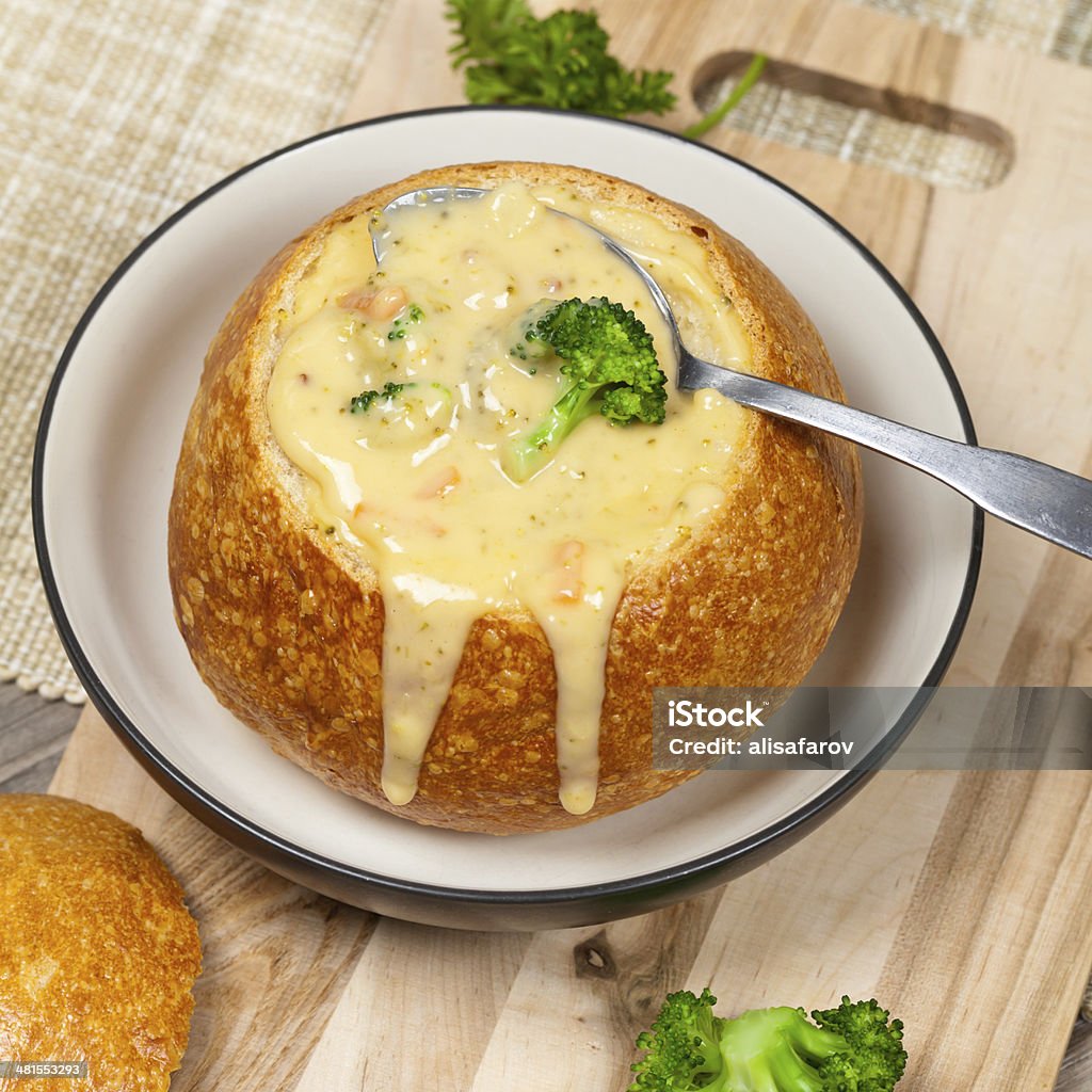 Broccoli and cheese soup Sourdough bread bowl filled with broccoli cheese soup 7-Grain Bread Stock Photo