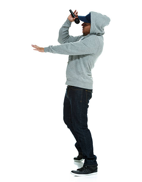 istock Side view of male rapper standing with microphone 481553553