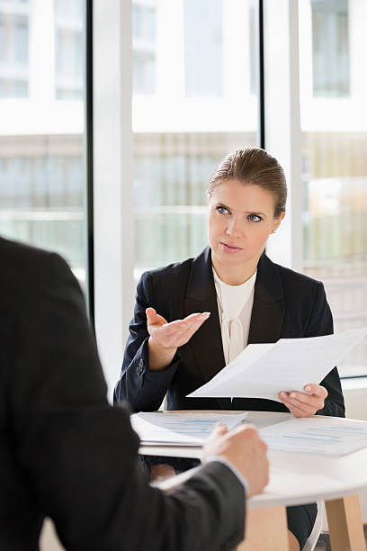 istock Businesswoman discussing over documents with colleague 481561209