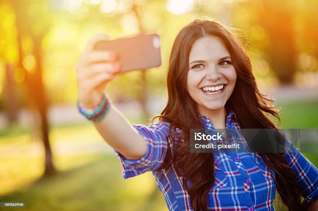Selfie Young woman with smart phone 20-29 Years Stock Photo
