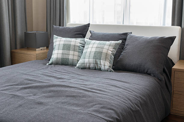 istock bedroom interior design with checked green pillows on grey bed 481564018