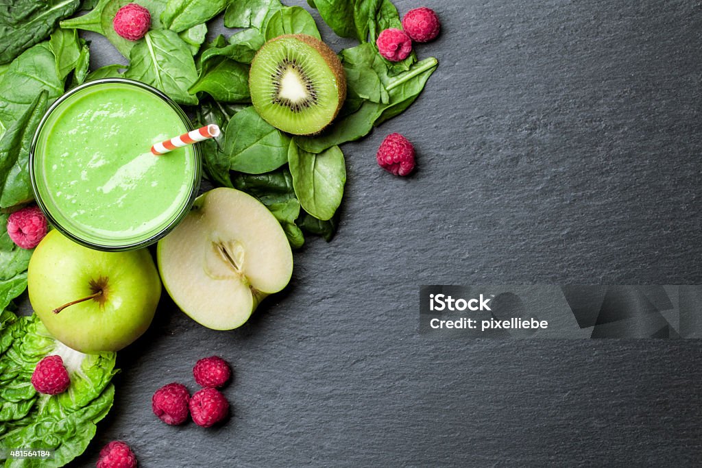 green smoothie with fruits and vegetables on black background 2015 Stock Photo