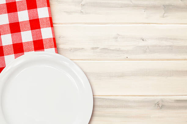 istock Red Checked Napkin with Dish on White Wooden Picnic Table 481564308