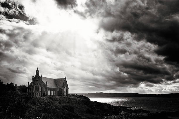 istock Coastal Church under dramatic sky black and white 481565229
