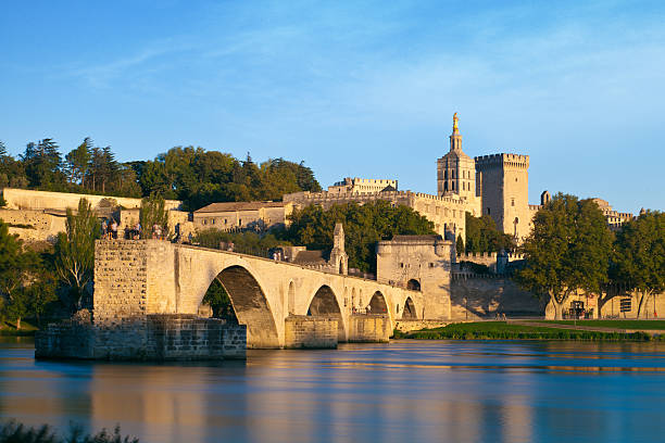 Avignon Bridge with Popes Palace and Rhone river, Provence, France Avignon Bridge with Popes Palace and Rhone river at sunrise, Pont Saint-Benezet, Provence, France avignon france stock pictures, royalty-free photos & images