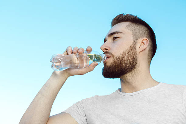 istock Young man drinking water, hot day 481567350
