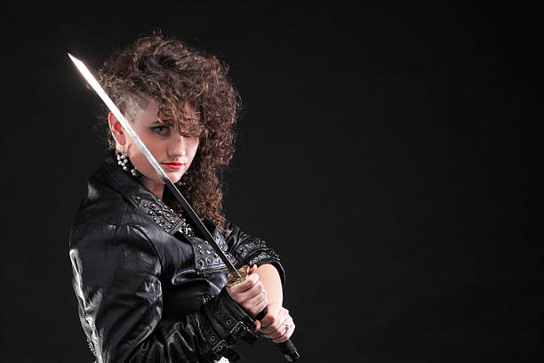istock piercing woman curly girl and sword 481567895