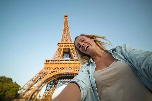 Photo of Girl taking selfie in Paris at the Eiffel tower