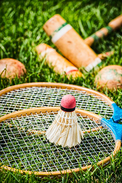 istock Vintage badminton rackets and shuttlecock lying in grass 481568078