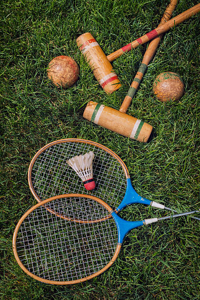 istock Vintage badminton rackets and shuttlecock lying in grass 481568382