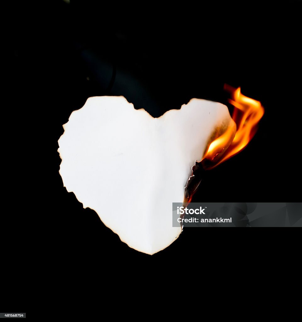 burning paper heart shape paper burning on black background Paper Stock Photo