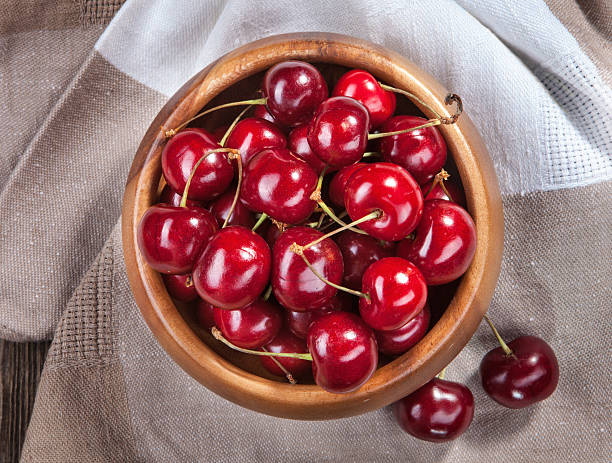 istock Ripe red cherries in a bowl on a table 481569794